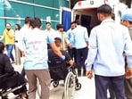 Medical personnel with injured passengers in wheelchairs after the Air India flight (AI2379) from Phuket to Delhi experienced brief in-flight turbulence.(ANI Video Grab)
