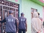 State Investigation Agency (SIA) Kashmir personnel conduct searches at a residential location in connection with a 1990 double-murder case, in Anantnag district, Jammu and Kashmir, on Wednesday. (PTI)