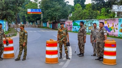 Security personnel stand guard near a road blocked amid security concerns, amid the ongoing protest by students and aspirants demanding a probe into alleged recruitment exam irregularities conducted by the JPSC and JSSC, near Jharkhand Chief Minister Hemant Soren's residence, in Ranchi, Jharkhand, Thursday, Aug. 13, 2026. (PTI) Security personnel stand guard near a road blocked amid security concerns, amid the ongoing protest by students and aspirants demanding a probe into alleged recruitment exam irregularities conducted by the JPSC and JSSC, near Jharkhand Chief Minister Hemant Soren's residence, in Ranchi, Jharkhand, Thursday, Aug. 13, 2026. (PTI)