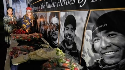 Woman place candles next to pictures of climbers who lost their lives on Broad Peak, during a candlelight vigil in their memory, in Islamabad, Pakistan, Tuesday, Aug. 11, 2026. (AP Photo/Anjum Naveed) Woman place candles next to pictures of climbers who lost their lives on Broad Peak, during a candlelight vigil in their memory, in Islamabad, Pakistan, Tuesday, Aug. 11, 2026. (AP Photo/Anjum Naveed)