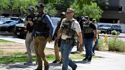 ICE agent pulls gun after Virginia woman confronts officers. (REUTERS)