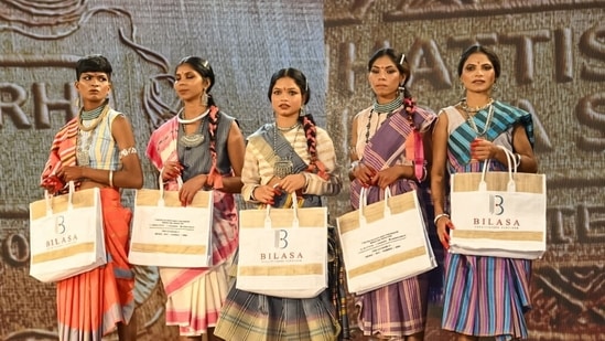 Surrendered women naxals pose for a group picture during their participation in a Tribal fashion show programme organised to mark National Handloom Day, in Raipur. (ANI Photo)
