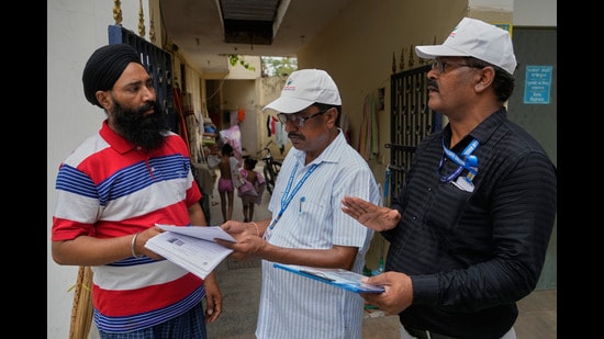 Booth Level Officers (BLO) from the Election Commission verifying and explaining the process of Special Intensive Revision (SIR). (AP Photo/Manish Swarup)