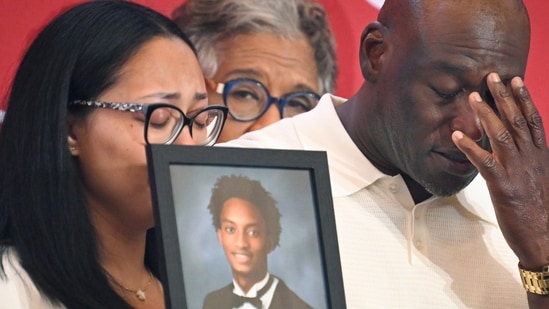 Elmore Wonsley, right, pauses from speaking as wife Christine Wonsley holds a photo of her deceased son, Nolan Wells, as they appear at the National Urban League's annual conference, Thursday, July 30, 2026, in Nashville, Tenn. (AP Photo/John Amis)