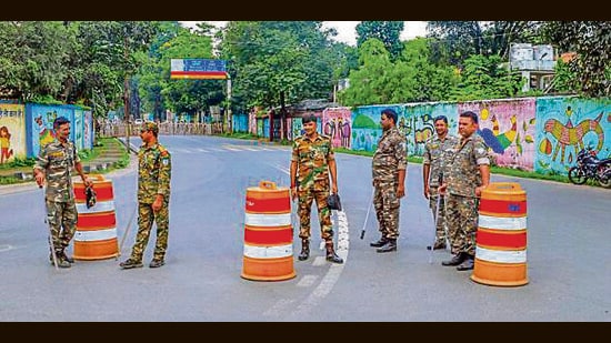 Security personnel stand guard near a road blocked amid security concerns near Jharkhand CM Hemant Soren's residence, in Ranchi, Thursday (PTI)