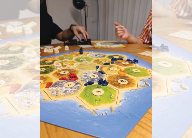 Playing Catan with your family can subdue the itch to check your phone. (ADOBE STOCK) Playing Catan with your family can subdue the itch to check your phone. (ADOBE STOCK)