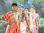 Surrendered women naxals walk on the ramp during a participation in a Tribal fashion show programme organised to mark National Handloom Day, in Raipur on Monday. (ANI Photo)
