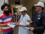 Booth Level Officers (BLO) from the Election Commission verifying and explaining the process of Special Intensive Revision (SIR). (AP Photo/Manish Swarup)