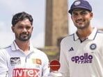 Galle: India's Captain Shubman Gill, right, along with Sri Lanka's Captain Dhananjay de Silva pose for photographs with the series trophy in the backdrop of Galle fort ahead of the first Test cricket match between Sri Lanka and India, in Galle, Sri Lanka, Friday, Aug. 14, 2026. (PTI Photo/Shailendra Bhojak)(PTI08_14_2026_000159A) (PTI)
