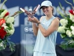 Iga Swiatek of Poland poses with the trophy after defeating Elena Rybakina of Kazakhstan. 