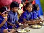 Children eat their mid-day meal in a school.