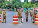 Security personnel stand guard near a road blocked amid security concerns near Jharkhand CM Hemant Soren's residence, in Ranchi, Thursday (PTI)