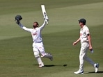 Tanzid Hasan celebrates scoring his century as Pat Cummins looks on. Tanzid Hasan celebrates scoring his century as Pat Cummins looks on.