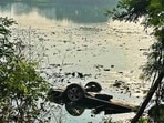 The car that plunged into a village pond in Bassian village, killing three of the occupants in Ludhiana on Thursday. (HT)