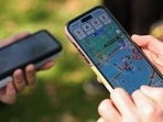 People play the Pokemon GO game on smartphones during the in-person Pokemon GO Tour.