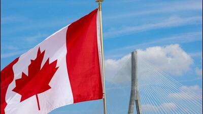 A Canadian flag flies near the Gordie Howe bridge connecting Windsor, Ontario, Canada, with Detroit, Michigan, US. (REUTERS) A Canadian flag flies near the Gordie Howe bridge connecting Windsor, Ontario, Canada, with Detroit, Michigan, US. (REUTERS)