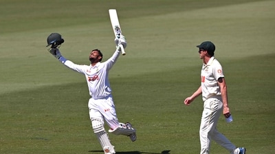Tanzid Hasan celebrates scoring his century as Pat Cummins looks on. (AFP) Tanzid Hasan celebrates scoring his century as Pat Cummins looks on. (AFP)