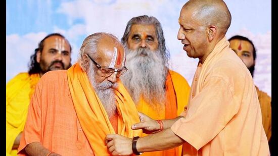 Chief minister Yogi Adityanath felicitates a seer during ‘Punya Smriti Mahamahotsav’ organised on the 23rd death anniversary of late Mahant Paramhans Ramchandra Das, in Ayodhya on Friday. (@myogiadityanath X/ANI Photo)