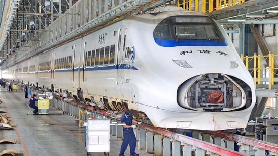 Workers maintain a high-speed train at Nantong High-Speed Train Depot in Nantong, China's eastern Jiangsu province on June 29, 2026.(AFP)