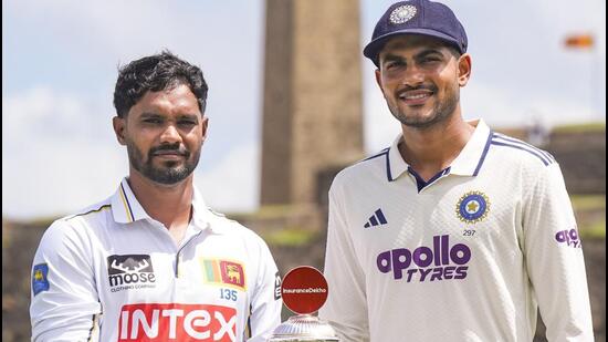 Galle: India's Captain Shubman Gill, right, along with Sri Lanka's Captain Dhananjay de Silva pose for photographs with the series trophy in the backdrop of Galle fort ahead of the first Test cricket match between Sri Lanka and India, in Galle, Sri Lanka, Friday, Aug. 14, 2026. (PTI Photo/Shailendra Bhojak)(PTI08_14_2026_000159A) (PTI)