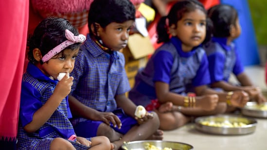 Children eat their mid-day meal in a school.