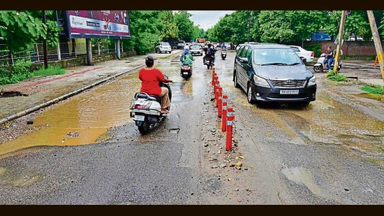 The road near the Zone-D MC office in a bad shape in Sarabha Nagar. (Gurpreet Singh/HT)