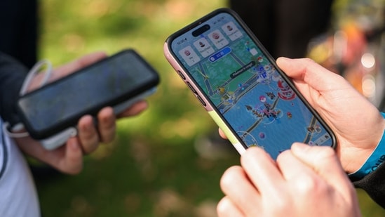 People play the Pokemon GO game on smartphones during the in-person Pokemon GO Tour. (AFP/ File Photo)