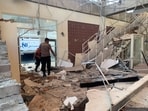 Rescuers inspect a heavily-damaged building at L. Say port, following an earthquake, in Sikka, East Nusa Tenggara province, Indonesia after a 7.7 magnitude earthquake
