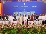 Karnataka chief minister DK Shivakumar and Governor Thawar Chand Gehlot pose with newly inducted ministers and other leaders after the swearing-in ceremony following the expansion of the state Cabinet at Lok Bhavan in Bengaluru. 