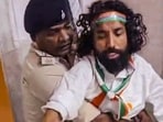 A video grab shows police personnel restraining student leader Devendra Nath Mahto as he attempts to leave the ICU of Sadar Hospital to participate in a 'Tiranga Yatra' on the occasion of Independence Day, in Ranch.