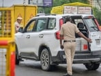 Delhi police stops a vehicle during a security check along a road ahead of India's Independence Day at Delhi Noida Border in New Delhi.