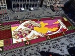 An overview of a giant flower carpet inspired by The Great Wave off Kanagawa by Japanese artist Katsushika Hokusai at the historic Grand Place in Brussels,
