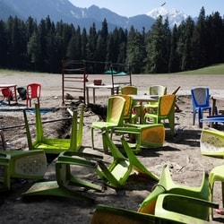 Chairs and tables scattered at the site of the terrorist attack on tourists in Baisaran near Pahalgam in south Kashmir's Anantnag district, last year. 