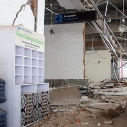 Phone charging booth sits among rubble at a heavily damaged building following an earthquake in Maumere, Sikka, East Nusa Tenggara province, Indonesia.
