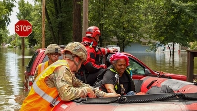 This handout photo distributed by the Indianapolis Fire Department shows first responders helping a resident in flood waters in Indianapolis, Indiana, on August 15. (AFP) This handout photo distributed by the Indianapolis Fire Department shows first responders helping a resident in flood waters in Indianapolis, Indiana, on August 15. (AFP)