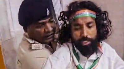A video grab shows police personnel restraining student leader Devendra Nath Mahto as he attempts to leave the ICU of Sadar Hospital to participate in a 'Tiranga Yatra' on the occasion of Independence Day, in Ranch. (PTI) A video grab shows police personnel restraining student leader Devendra Nath Mahto as he attempts to leave the ICU of Sadar Hospital to participate in a 'Tiranga Yatra' on the occasion of Independence Day, in Ranch. (PTI)