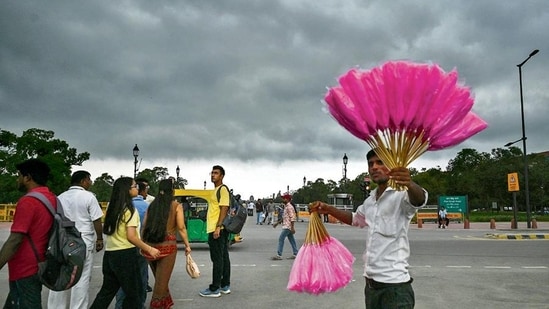 Gram it: With an overcast sky in the background, this cotton candy seller looks spectacular with his stock of sale that he sells at Kartavya Path where visitors gathered in huge numbers during the Independence Day weekend. The weather department has issued a forecast of generally cloudy sky for today, with light spells of rain.