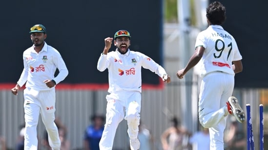 Mehidy Hasan Miraz (centre) celebrates the wicket of an Aussie batsman with his bowler.