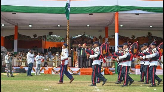 Haryana Deputy Speaker Dr Krishan Lal Middha takes the salute of the parade during the 80th Independence Day celebrations at Tau Devi Lal Stadium on Saturday. (Parveen Kumar/HT)