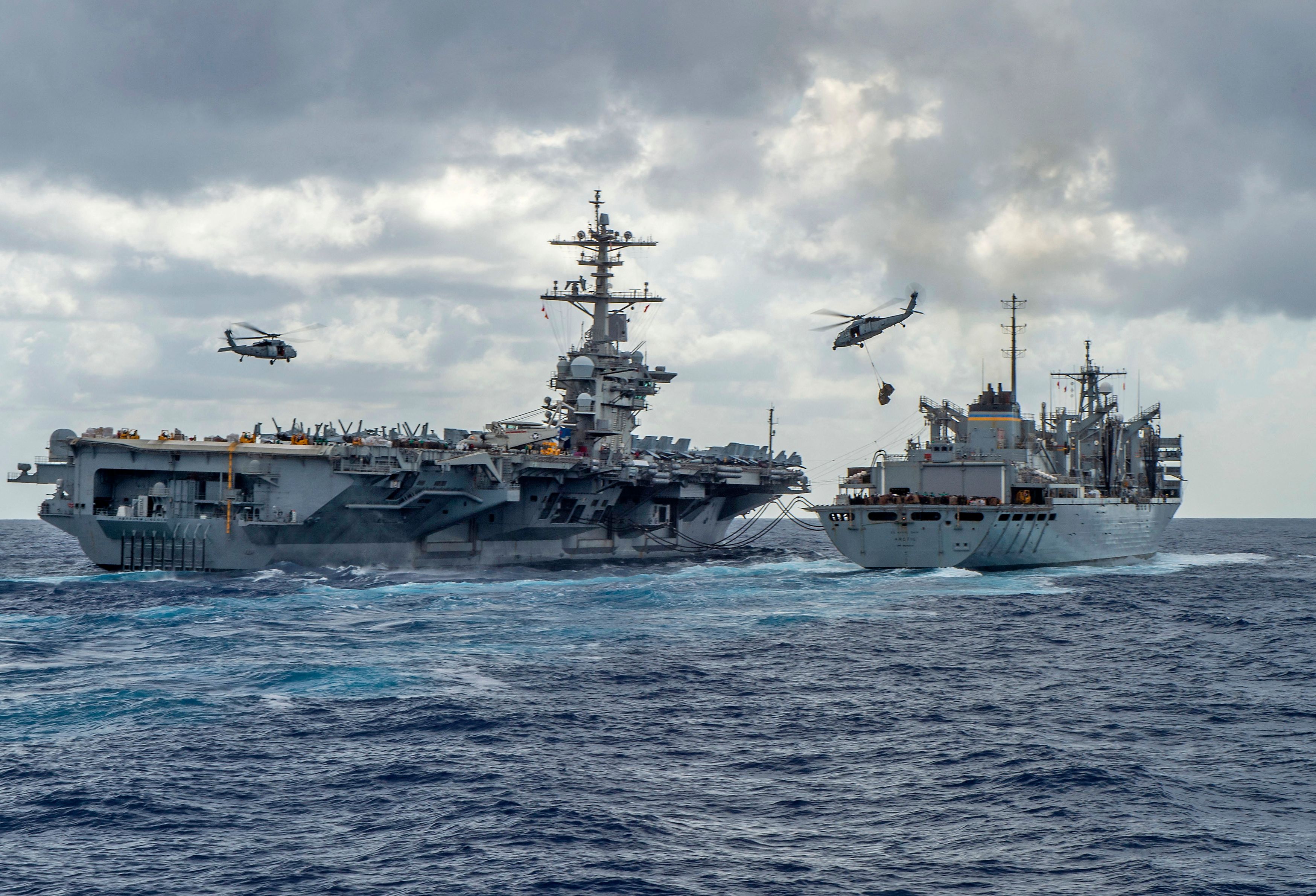 US Navy photo shows USS Abraham Lincoln conducting an at-sea replenishment with USNS Arctic, as helicopters transfer supplies between the ships. (AFP) US Navy photo shows USS Abraham Lincoln conducting an at-sea replenishment with USNS Arctic, as helicopters transfer supplies between the ships. (AFP)