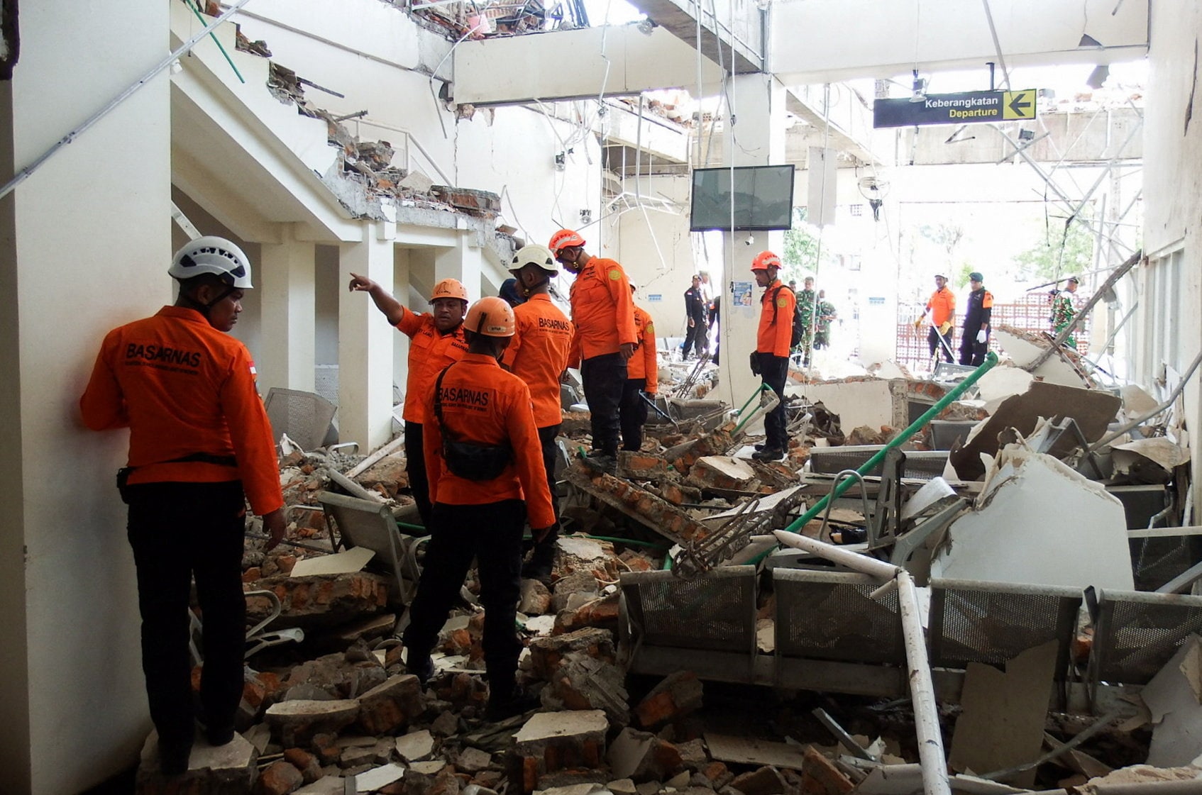 Rescuers inspect a heavily-damaged building at L. Say port  following an earthquake in Maumere, Sikka, East Nusa Tenggara province, Indonesia, (REUTERS)