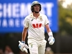 Australia's batsman Pat Cummins walks off after his dismissal. 