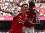 Martin Odegaard celebrates with Kai Havertz after scoring their third goal during the English FA Community Shield.(AFP)
