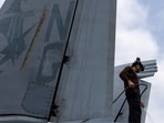 A U.S. sailor, assigned to Electronic Attack Squadron 133, washes an EA-18G Growler on the flight deck of the Nimitz-class aircraft carrier USS Abraham Lincoln during the ongoing conflict with Iran August 9, 2026.  U.S. Navy/Handout via REUTERS  THIS IMAGE HAS BEEN SUPPLIED BY A THIRD PARTY.
