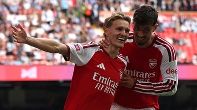 Martin Odegaard celebrates with Kai Havertz after scoring their third goal during the English FA Community Shield. (AFP)