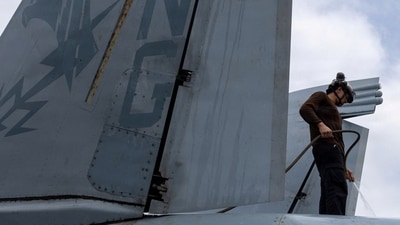 A U.S. sailor, assigned to Electronic Attack Squadron 133, washes an EA-18G Growler on the flight deck of the Nimitz-class aircraft carrier USS Abraham Lincoln during the ongoing conflict with Iran August 9, 2026.  U.S. Navy/Handout via REUTERS  THIS IMAGE HAS BEEN SUPPLIED BY A THIRD PARTY. (via REUTERS)