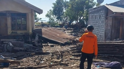 Rescuers on Sunday dug through debris looking for people feared buried beneath landslides triggered by the quake. (BASARNAS via AP) Rescuers on Sunday dug through debris looking for people feared buried beneath landslides triggered by the quake. (BASARNAS via AP)