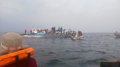 Rescue workers and local boat operators took part in ongoing search and recovery operations near the overturned passenger ferry on Lake Kariba, after the vessel capsized in Kariba, Zimbabwe. (File Photo/Reuters)