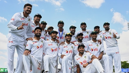 Bangladesh players pose for a team photo as they celebrate after defeating Australia.(AP)