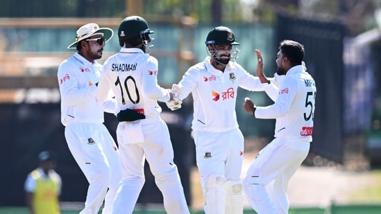 Mehidy Hasan Miraz, right, of Bangladesh is congratulated by teammates. (James Ross/AAP Image via AP)
